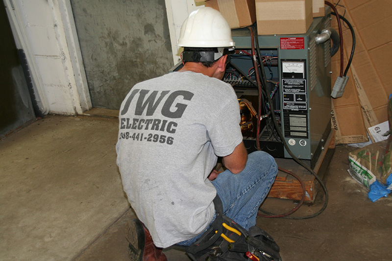 A residential electrician working on a furnace upgrade in Chester, NJ